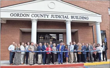  ?? Blake silvers ?? Joined by a host of local, state and federal officials and luminaries, as well as court staff, Chief Judge Scott Smith cuts the ribbon on the newly renovated and expanded Gordon County Judicial Building on Piedmont Street in April. Smith called the courthouse the “center of the community.”