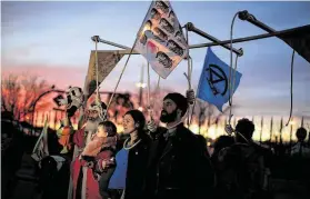  ?? Manu Fernandez / Associated Press ?? Activists protest Saturday in Madrid, where world leaders held talks to hammer out the final details of the 2015 Paris climate accord. The delegates from nearly 200 nations have had difficulty agreeing on targets for the coming year.