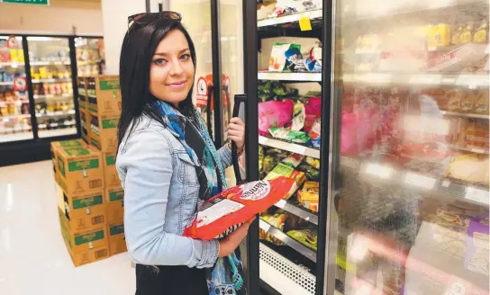  ?? Picture: TARA CROSER ?? SOURCE CONFUSION: Amy Maher, 21, shops for frozen food in Coles yesterday.