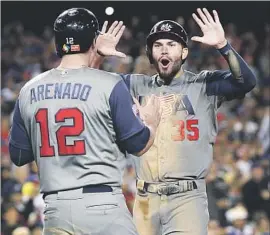  ?? Allen J. Schaben Los Angeles Times ?? NOLAN ARENADO and Eric Hosmer score on a single by Brandon Crawford in the seventh inning to put the U.S. ahead, 6-0, on the way to winning WBC title.