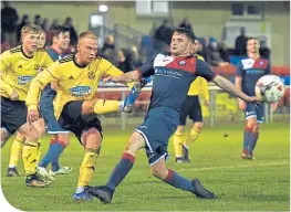  ??  ?? Cove’s Jordon Brown clears the ball from Turriff’s Michael Ironside