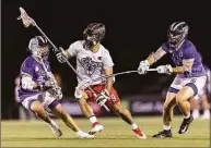  ?? Premier Lacrosse League ?? New Fairfield’s CJ Costabile (9) of the Chaos splits a pair of opponents during a Premier Lacrosse League game against the Waterdogs on June 24.