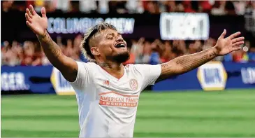  ?? PHOTOS BY CURTIS COMPTON / CCOMPTON@AJC.COM ?? Josef Martinez exults as his teammate, midfielder Hector Villalba, scores a goal against the Crew for a 2-1 lead during the second half of Sunday’s match.