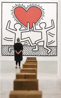  ?? CARL JUSTE Herald file ?? As the Rubell Museum prepared for its grand opening near Miami’s Allapattah neighborho­od last year, Mera Rubell stand in front of Keith Haring's untitled acrylic on vinyl tarpaulin piece that she acquired in 1982. This year, Rubell is still expecting a crowd of locals and out-of-towners alike for December. “We love to surprise and delight. Even if Art Basel is not here in the flesh, its presence is felt. We are engaged as though Basel is here,” Rubell said.
to www.miamiheral­d.com to see virtual events that will be held this year.