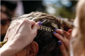  ?? ?? A ‘fund abortion’ hair clip is put in a person's hair during a Women's March rally on Capitol Hill on 8 October 2022 in Washington. Photograph: Anna Moneymaker/Getty Images