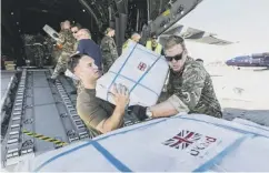  ??  ?? 0 RAF personnel unload vital emergency aid in Mozambique