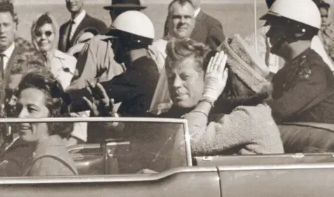  ?? Picture: AP ?? MOMENTS FROM DEATH: In this 1963 file photo, President John F. Kennedy waves from his car in a motorcade in Dallas. Riding with Kennedy are First Lady Jacqueline Kennedy, Nellie Connally, and her husband, Texas Governor John Connally.