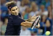  ?? — AFP ?? Roger Federer returns to Stan Wawrinka in their Western and Southern Open match in Mason, Ohio, on Friday. Federer won 6- 7 ( 2/ 7), 7- 6 ( 8/ 6), 6- 2.