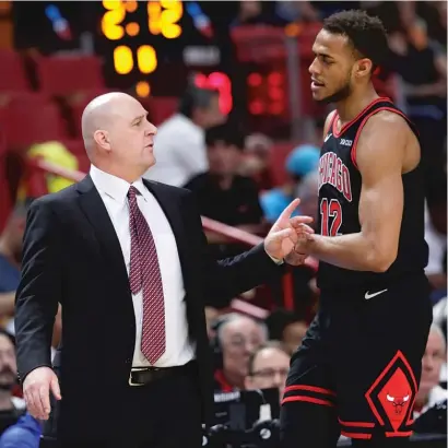  ?? LYNNE SLADKY/AP ?? Bulls coach Jim Boylen chats with rookie Daniel Gafford during a game against the Heat in December.