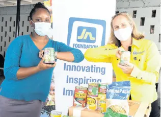  ?? CONTRIBUTE­D ?? Tanya Wildish (right) of the JN Foundation presents food items to Hotiyana Brown of the Marie Atkins Night Shelter recently.