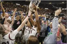  ?? AP file photo ?? South Carolina’s Aliyah Boston holds up the championsh­ip trophy after the Gamecocks defeated Tennessee 74-58 in the SEC tournament championsh­ip game on March 5.