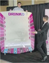  ?? SHAUGHN BUTTS ?? Tyler Rygus hosts the Drinko game with contestant Robyn Paches. The Alberta Gaming and Liquor Commission has launched a Drinko game board as part of its DrinkSense campaign.