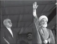  ?? AP/VAHID SALEMI ?? Iranian President Hassan Rouhani, shown at a campaign rally Sunday with Foreign Minister Mohammad Javad Zarif, was expected to benefit politicall­y from the nuclear deal but finds himself in a re-election race.