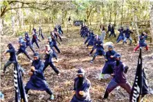  ??  ?? Members of the Khilafah Islamiyah Movement and its shadowy group Ghuraba (strangers) train their fighters in Lanao del Sur province in the Muslim autonomous region in Mindanao in this screen shot from the propaganda video of Islamic State in the...