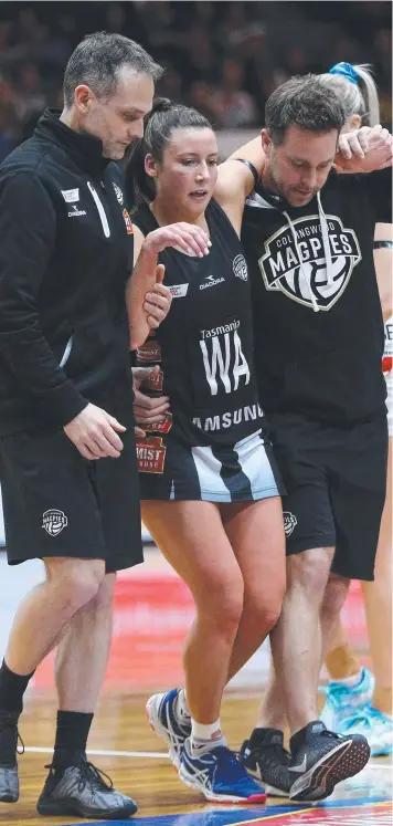  ?? Picture: AAP ?? LIMPING OFF: Collingwoo­d’s Kelsey Browne is helped off the court after being injured during last weekend’s match against the NSW Swifts in Launceston.