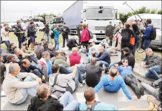  ??  ?? Employees of French auto parts manufactur­er GM&S demonstrat­e on Sept 5, in front of a plant of French car maker PSA Peugeot Citroen in Poissy, outside Paris. The court on Sept 4 set its ruling on the only takeover offer of GM&S by French company GMD,...