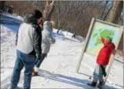  ??  ?? Friends of Peebles Island State Park president Dave DeMarco explains points on a park map to event-goers during a New Year Hike on Sunday.