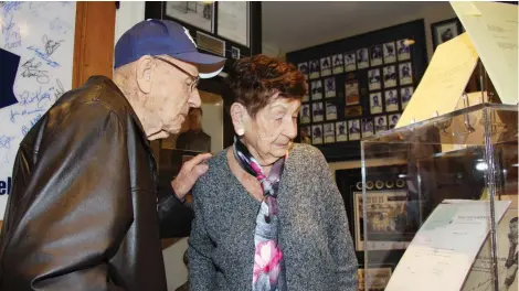  ?? DAN NICHOLSON/SPECIAL TO POSTMEDIA ?? Johnny Bower and his wife Nancy tour superfan Mike Wilson’s Maple Leafs shrine.
