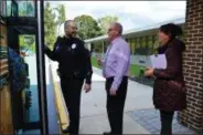  ?? SUBMITTED PHOTO ?? Officer Scott Myers of the West Goshen Police Department prepares to board a bus leaving Glen Acres Elementary School with John Scully, WCASD Director of Business Affairs, and Lori Aguilera, project director for the Chester County Highway Safety Project.