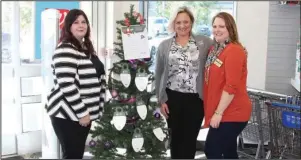  ?? The Sentinel-Record/Tanner Newton ?? SENIOR TREE: From left are Christina Godfrey, Jennifer Bassett and Kandy Gould of Home Instead with one of the Be a Santa to a Senior program’s trees at Walgreens. The tree is covered in ornaments bearing the names and wish lists of local seniors who do not have families nearby to be with during the holidays.