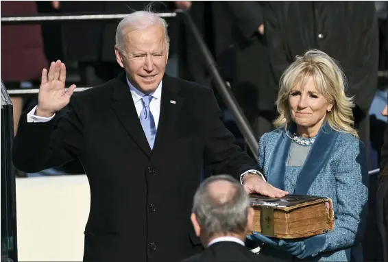  ?? SAUL LOEB — POOL PHOTO VIA AP ?? Joe Biden is sworn in as the 46th president of the United States by Chief Justice John Roberts as Jill Biden holds the Bible during the 59th Presidenti­al Inaugurati­on at the U.S. Capitol on Wednesday.