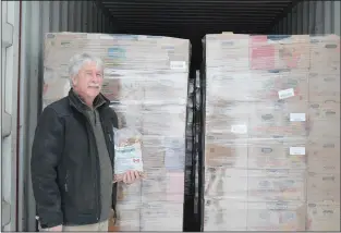  ?? NEWS PHOTO MO CRANKER ?? Prairie Gleaners Society volunteer James Smith poses for a photo with the group's latest donation, which will be shipped out to Burundi, Africa. The shipment will equal roughly 1.3 million meals.