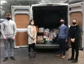  ??  ?? Pupils load the donations for delivery