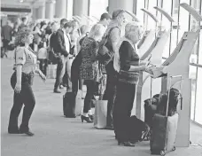  ?? JOE RAEDLE, GETTY IMAGES ?? Passengers use the passport control kiosks set up for internatio­nal travelers arriving at Miami Internatio­nal Airport.