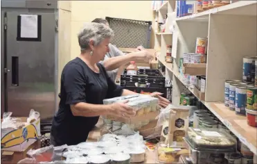  ?? / Kevin Myrick ?? Volunteers help keep the shelves stocked and bags filled at the Helping Hands Food Pantry in Rockmart.