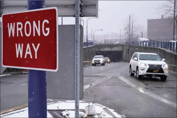  ?? (AP/Steven Senne) ?? A “wrong way” sign warns drivers Thursday against entering westbound on an eastbound exit ramp from the Massachuse­tts Turnpike, Route I-90, in Boston.