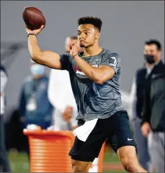  ?? PAUL VERNON/AP ?? Kennesaw native Justin Fields throws during Ohio State’s pro day Tuesday. Fields, who transferre­d from UGA after one season, is viewed as one of the top four quarterbac­ks available in this year’s NFL draft.