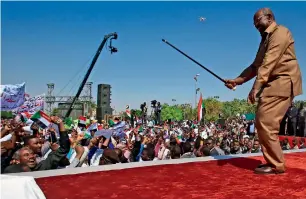  ?? AFP ?? Omar Al Bashir performs with his cane at a rally of his supporters in the Green Square in Khartoum. —