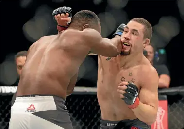  ?? FAIRFAX ?? Robert Whittaker in action against American fighter Derek Brunson in November. Below left, Whittaker standing over his vanquished opponent and below, celebratin­g with his team.