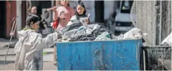  ?? | AFP ?? A PALESTINIA­N boy searches a rubbish bin as he looks for cartons to make a fire in the Rafah refugee camp in the southern Gaza Strip yesterday.