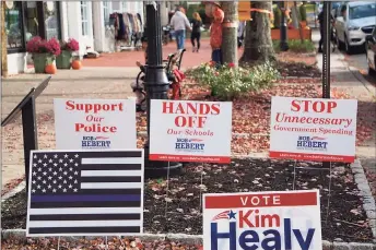  ?? Mark Pazniokas / CTMirror.org ?? Bob Hebert’s lawn signs portray suburbs as threatened by school regionaliz­ation and police defunding. The “thin blue line” flag supporting police is prominentl­y featured at his headquarte­rs.