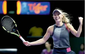  ??  ?? Denmark’s Caroline Wozniacki celebrates her 7-6 (11/9), 6-3 win over Karolina Pliskova of the Czech Republic in their singles semi-final at the WTA tennis tournament in Singapore on Saturday. —