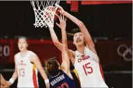  ?? Charlie Neibergall / Associated Press ?? China’s Han Xu (15) shoots over Serbia’s Tina Krajisnik during a quarterfin­al game at the 2020 Summer Olympics in 2021 in Saitama, Japan.