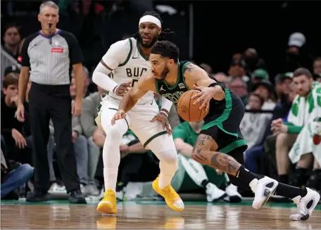  ?? MATT STONE — BOSTON HERALD ?? Celtics forward Jayson Tatum gets around Malik Beasley of the Milwaukee Bucks during the first half at the TD Garden.