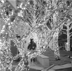  ??  ?? People are seen during a lights festival at a business centre ahead of Christmas Eve in Beijing, China. — Reuters photo