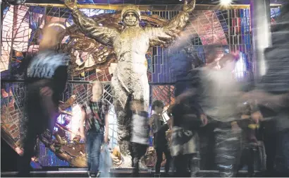  ?? Picture: AFP ?? NATIONAL HERO. People walk past a statue of Yuri Gagarin as they visit the Museum of Cosmonauti­cs in Moscow, last week. Gagarin died on a plane 50 years ago and his death remains a mystery.