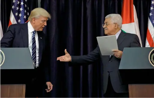  ?? Reuters ?? Palestinia­n President Mahmoud Abbas extends his hand to US President Trump during a joint news conference in the West Bank city of Bethlehem on Tuesday. —