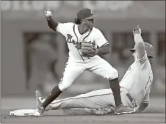  ?? Todd Kirkland / AP ?? Atlanta second baseman Ozzie Albies (left) throws to first after the force-out of Philadelph­ia’s Rhys Hoskins (right) in the first inning of Saturday’s game.