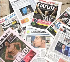  ??  ?? Photo shows the Italian newspapers front pages enlighteni­ng the arrival of Portugal’s Cristiano Ronaldo at the Italian Serie A club Juventus in Turin. — AFP photos