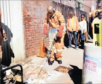  ?? PICTURE: DIMPHO MAJA ?? HAZARD: The City of Joburg has embarked on replacing old, steel manhole covers with ones made of polymer, which is of no commercial value. Mayor Herman Mashaba launched the project in Newtown yesterday.