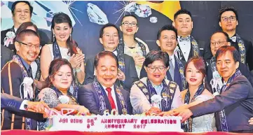  ??  ?? Soon Koh (front, third left) leads the cakecuttin­g ceremony involving (front, from left) Andrew, Chiew, Nurul Huda, Pet and Hii.