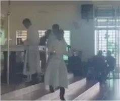  ??  ?? A screengrab from the video shows the altar boys removing candles as the church band (at right) play a Hari Raya song at the Holy Family Pilgrimage Centre Nulu Sosopon.