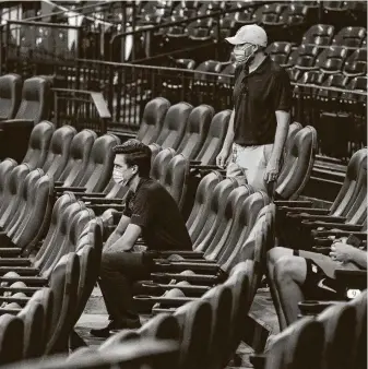  ?? Karen Warren / Staff photograph­er ?? Astros general manager James Click, right, hopes to see his team back on the field Tuesday night against the Rangers after seeing Sundays game postponed and having Monday off.