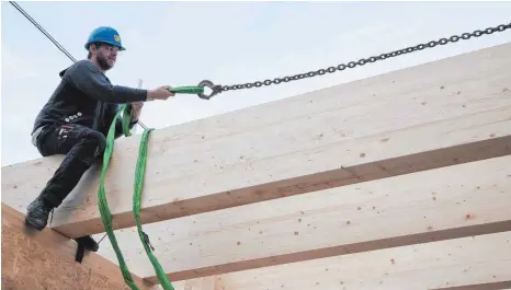  ?? FOTOS: DPA ?? Hoch hinaus: Zimmerleut­e sind auf der Baustelle unter anderem für den Dachstuhl zuständig.