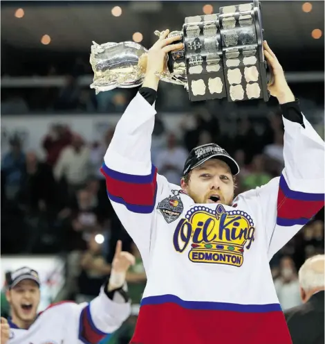  ?? Dave Chidley/The Canadian Press /File ?? Griffin Reinhart, then captain of the Edmonton Oil Kings, lifts the Memorial Cup after beating the Guelph Storm May 2014.