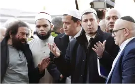  ??  ?? PARIS: Imam of one of the Nimes Mosque, Hocine Drouiche (2nd R), French author Marek Halter (L), Imam of the Drancy Mosque, Hassene Chalghoumi (C) and representa­tive of the Jewish community gather at a makeshift memorial near the Bataclan concert hall...